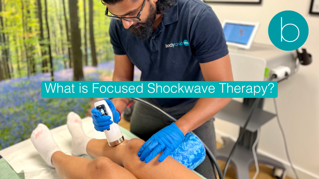 A healthcare professional at Bodytonic Clinic applying Focused Shockwave Therapy (FSWT) to a patient's lower back for chronic pain relief.
